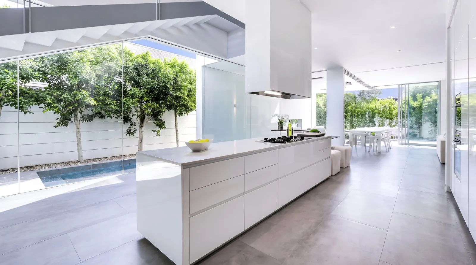 White kitchen island opening onto the garden